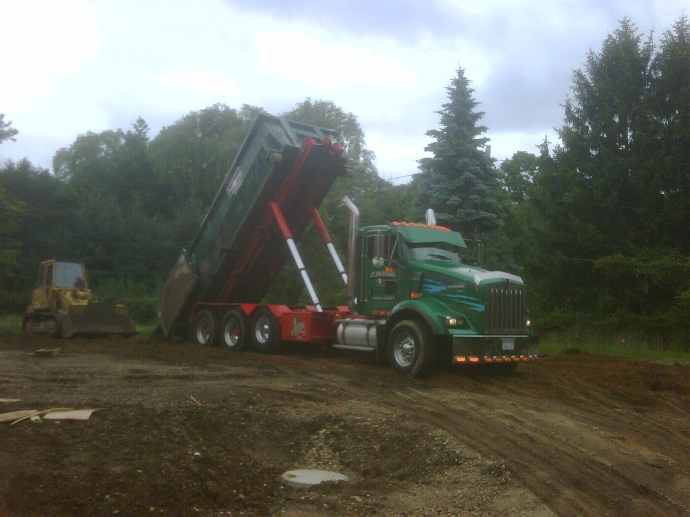 Roll-off container being set at a job site at no charge